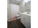 Bathroom featuring a white vanity, toilet, shower with tub and dark laminate flooring at 262 Devynwood Ln, Dallas, GA 30157