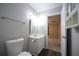 Bright bathroom featuring a white vanity, toilet, and wood-look flooring at 262 Devynwood Ln, Dallas, GA 30157