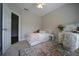 Bright bedroom with a decorative rug, a white vanity with an accompanying chair and an open door to another room at 262 Devynwood Ln, Dallas, GA 30157