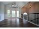 Dining room featuring hardwood floors, wainscoting, modern pendant light and a staircase at 262 Devynwood Ln, Dallas, GA 30157