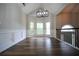 Dining room featuring hardwood floors, wainscoting, and a modern pendant light at 262 Devynwood Ln, Dallas, GA 30157
