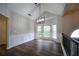 Dining room with wainscoting, hardwood floors and a modern pendant light at 262 Devynwood Ln, Dallas, GA 30157