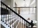 Welcoming entryway features a staircase with black iron railings, a console table with decor and a view into the living room at 262 Devynwood Ln, Dallas, GA 30157