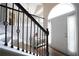 Bright foyer featuring a white front door with sidelights, a staircase with black iron railings, and a decorative console table at 262 Devynwood Ln, Dallas, GA 30157