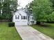 Charming two-story home featuring white siding, black shutters and a two car garage at 262 Devynwood Ln, Dallas, GA 30157