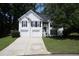 Charming two-story home featuring white siding, black shutters and a two car garage at 262 Devynwood Ln, Dallas, GA 30157