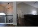 Hallway with hardwood floors, stairs, and modern light fixture, and vaulted ceiling for architectural interest at 262 Devynwood Ln, Dallas, GA 30157