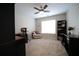 Well-lit home office with neutral walls, a ceiling fan, a chair by the window, and a built-in desk at 262 Devynwood Ln, Dallas, GA 30157
