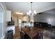Eat-in kitchen flows into an open living area with stainless steel appliances and breakfast bar at 262 Devynwood Ln, Dallas, GA 30157