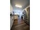 Bright, updated kitchen showcasing stainless steel appliances, granite counters and dark hardwood floors at 262 Devynwood Ln, Dallas, GA 30157