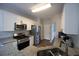 Galley kitchen featuring stainless steel appliances, granite countertops, and tiled backsplash at 262 Devynwood Ln, Dallas, GA 30157