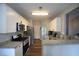 Galley kitchen featuring stainless steel appliances, granite countertops, and tiled backsplash at 262 Devynwood Ln, Dallas, GA 30157