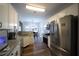Modern kitchen featuring stainless steel appliances, granite countertops, and white cabinets at 262 Devynwood Ln, Dallas, GA 30157