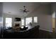 Open-concept living room with fireplace, ceiling fan, and hardwood floors leading to dining area at 262 Devynwood Ln, Dallas, GA 30157