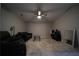 Large living room boasts neutral carpet, ceiling fan, glass table and comfortable sofas at 262 Devynwood Ln, Dallas, GA 30157