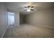 Neutral carpet, and a ceiling fan complete this large living room at 262 Devynwood Ln, Dallas, GA 30157