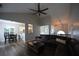 Bright and airy living room with hardwood floors, ceiling fan, and view of dining area and kitchen at 262 Devynwood Ln, Dallas, GA 30157