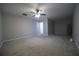 This open living room features neutral carpet, ceiling fan, and ample space at 262 Devynwood Ln, Dallas, GA 30157
