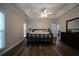 Spacious main bedroom features a tray ceiling, fan, and hardwood floors at 262 Devynwood Ln, Dallas, GA 30157