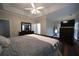 Beautifully furnished main bedroom has a tray ceiling, fan, and hardwood floors at 262 Devynwood Ln, Dallas, GA 30157
