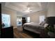 Spacious main bedroom features a tray ceiling, fan, and hardwood floors at 262 Devynwood Ln, Dallas, GA 30157