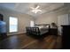 Spacious main bedroom features a tray ceiling, fan, and hardwood floors at 262 Devynwood Ln, Dallas, GA 30157