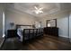 Spacious main bedroom features a tray ceiling, fan, and hardwood floors at 262 Devynwood Ln, Dallas, GA 30157