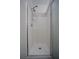 All-white walk-in shower with chrome hardware and tiled surround at 262 Devynwood Ln, Dallas, GA 30157