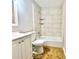 Tiled bathroom featuring a tub, white cabinetry, and a modern shower head at 4363 Stonewall Tell Rd, Atlanta, GA 30349