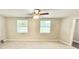 Spacious main bedroom featuring new carpet, plenty of natural light, and an attached bathroom at 4363 Stonewall Tell Rd, Atlanta, GA 30349