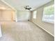 Bright living room featuring neutral walls and carpets with windows for natural light and a ceiling fan at 4363 Stonewall Tell Rd, Atlanta, GA 30349