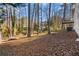 A spacious backyard with natural wooded views and a walkout deck, perfect for outdoor living at 7000 Woodland Nw Pl, Kennesaw, GA 30152