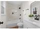 Modern bathroom featuring sleek fixtures, tiled shower with niche, and stylish vanity at 7000 Woodland Nw Pl, Kennesaw, GA 30152