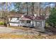 Charming single-Gathering home with a cozy front porch and attached one-car garage at 7000 Woodland Nw Pl, Kennesaw, GA 30152