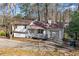 Charming single-Gathering home with a cozy front porch and attached one-car garage at 7000 Woodland Nw Pl, Kennesaw, GA 30152