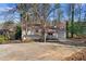 Quaint single-Gathering home featuring a cozy porch and an attached one-car garage at 7000 Woodland Nw Pl, Kennesaw, GA 30152
