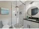 Modern bathroom featuring glass shower, white vanity, granite counters and decorative round mirror at 1329 Hidden Hills Pkwy, Stone Mountain, GA 30088
