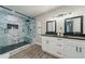 Modern bathroom showcasing a glass shower with marble tile and dual vanity with black hardware at 1329 Hidden Hills Pkwy, Stone Mountain, GA 30088