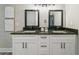 Bathroom vanity featuring double sinks, granite counters, and white cabinetry with black hardware at 1329 Hidden Hills Pkwy, Stone Mountain, GA 30088