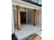 Inviting front entry featuring stylish wood columns and modern light fixture at 1329 Hidden Hills Pkwy, Stone Mountain, GA 30088