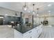 Open concept kitchen with white cabinets, an island, and dining and living areas adjacent at 1329 Hidden Hills Pkwy, Stone Mountain, GA 30088
