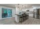 Modern kitchen featuring sleek stainless steel appliances, black countertops, and a large island at 1329 Hidden Hills Pkwy, Stone Mountain, GA 30088