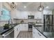 Kitchen boasts stainless appliances, white cabinetry, and a black countertop and hardware at 1329 Hidden Hills Pkwy, Stone Mountain, GA 30088