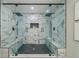Luxurious shower showcasing marble-patterned tiling, dual shower heads, and built-in bench seating at 1329 Hidden Hills Pkwy, Stone Mountain, GA 30088