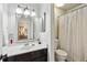 Clean and modern bathroom with white vanity, framed mirror, and shower-tub combination at 162 Lablanc Nw Way, Atlanta, GA 30327