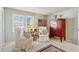 Bright bedroom featuring white armchairs, an american flag, and red furniture piece at 162 Lablanc Nw Way, Atlanta, GA 30327