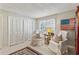 Bright bedroom featuring white armchairs, a window, and ample closet space at 162 Lablanc Nw Way, Atlanta, GA 30327