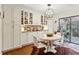 Bright dining area with stylish lighting, white cabinetry and a large sliding glass door at 162 Lablanc Nw Way, Atlanta, GA 30327