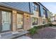 Charming townhome featuring brick facade and dark trim windows, complemented by lush green landscaping at 162 Lablanc Nw Way, Atlanta, GA 30327