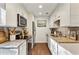 Well-lit kitchen featuring white cabinetry, granite countertops, stainless steel appliances, and wood flooring at 162 Lablanc Nw Way, Atlanta, GA 30327